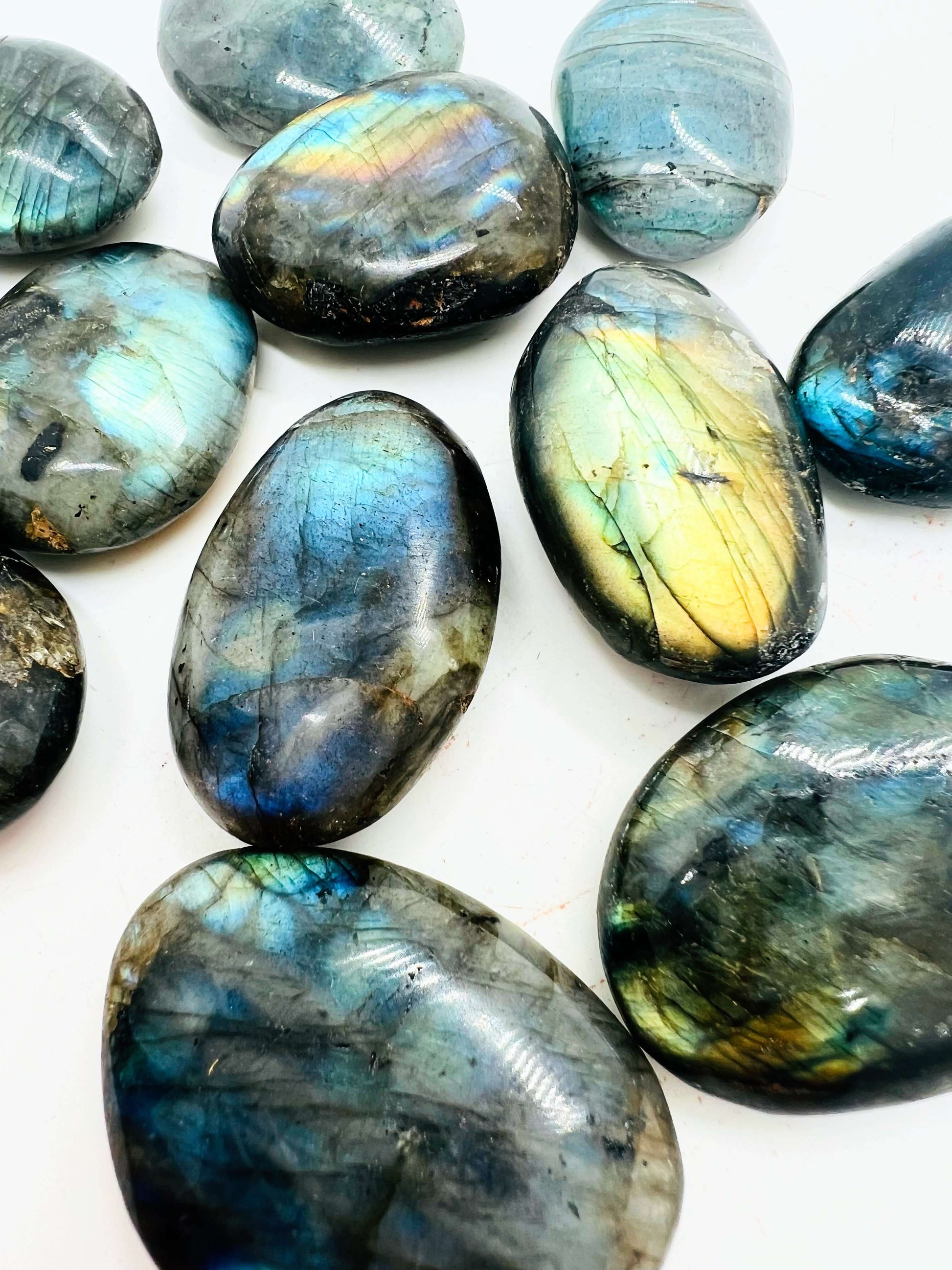 Polished labradorite stone displaying iridescent colors and intricate patterns.