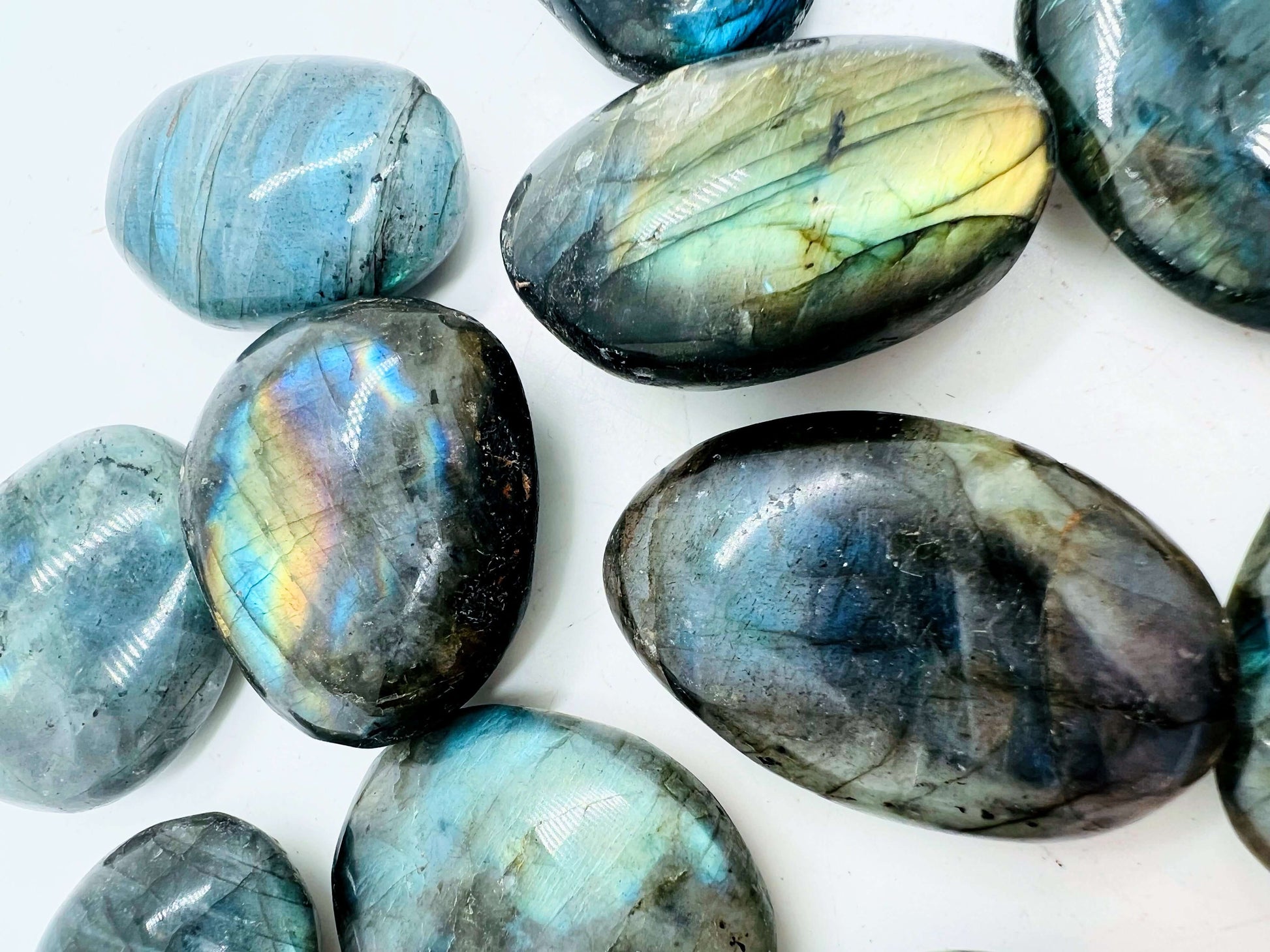 Polished labradorite stone displaying iridescent colors and intricate patterns.