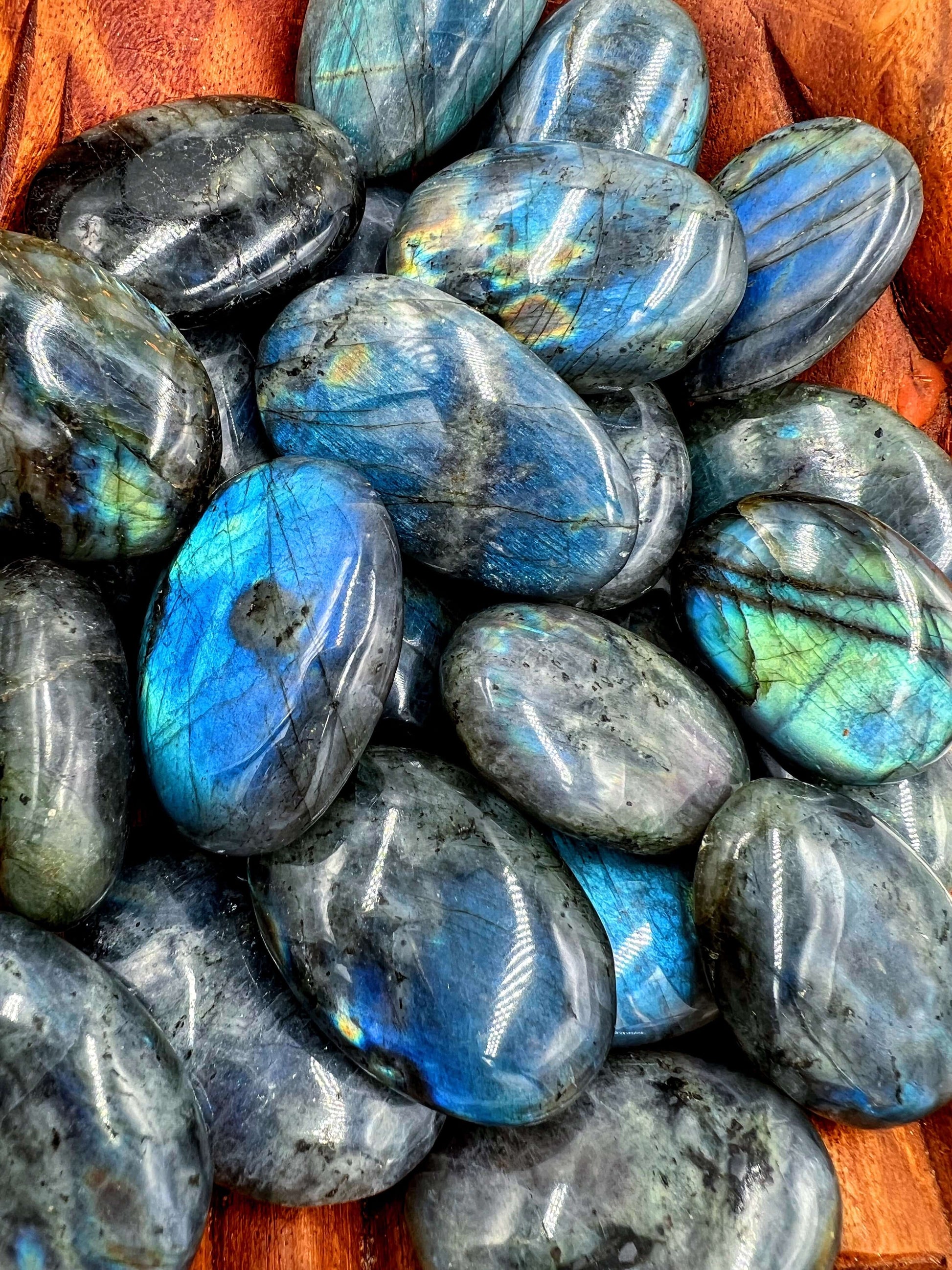 close up image Polished labradorite stone displaying iridescent colors and intricate patterns.