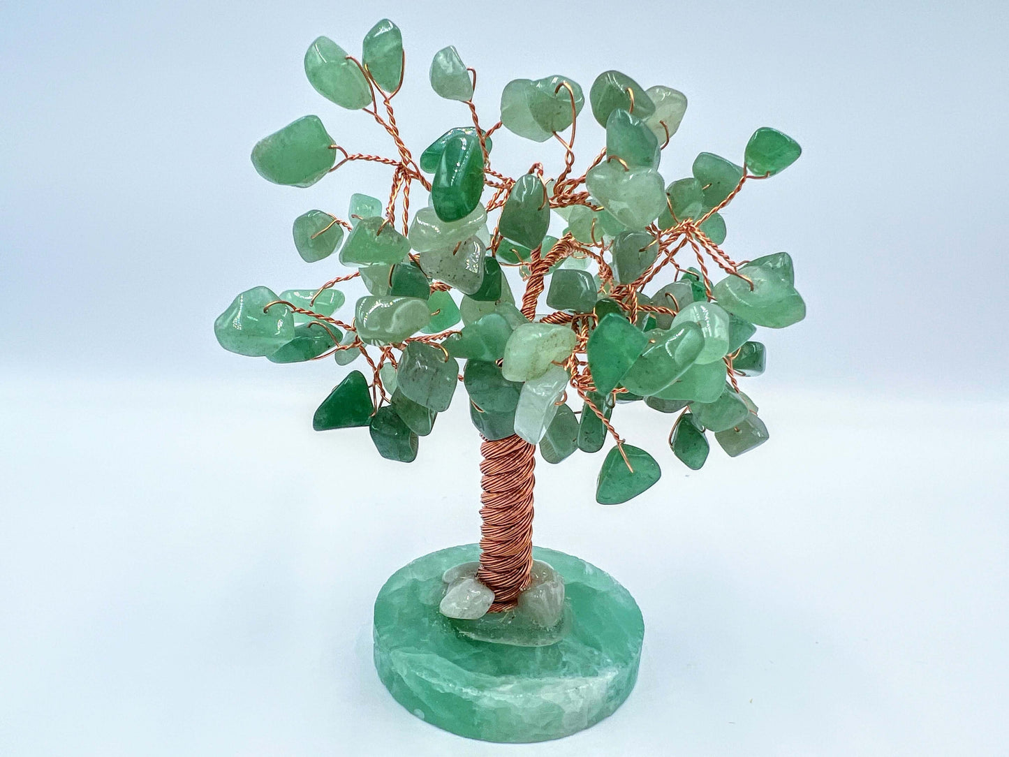 Green aventurine crystal gem tree on white surface