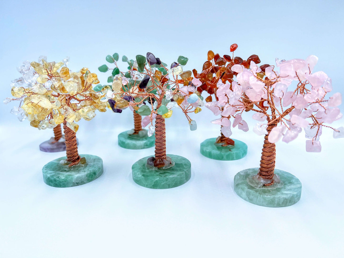 Several gem trees on white surface. 