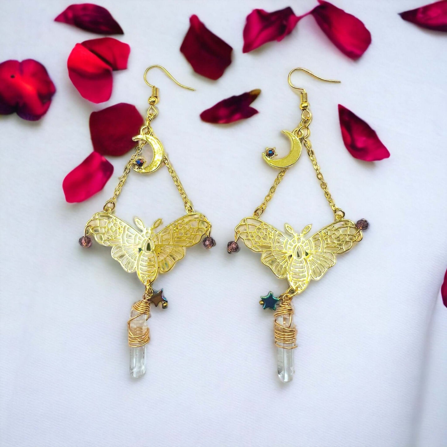 Gold colour moth earrings with crystals.