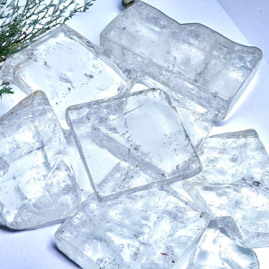 Clear quartz slabs on white surface. 