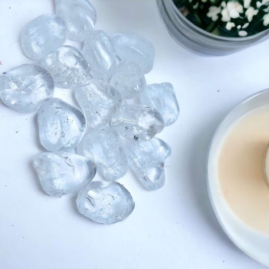 Clear quartz tumbles on white surface 