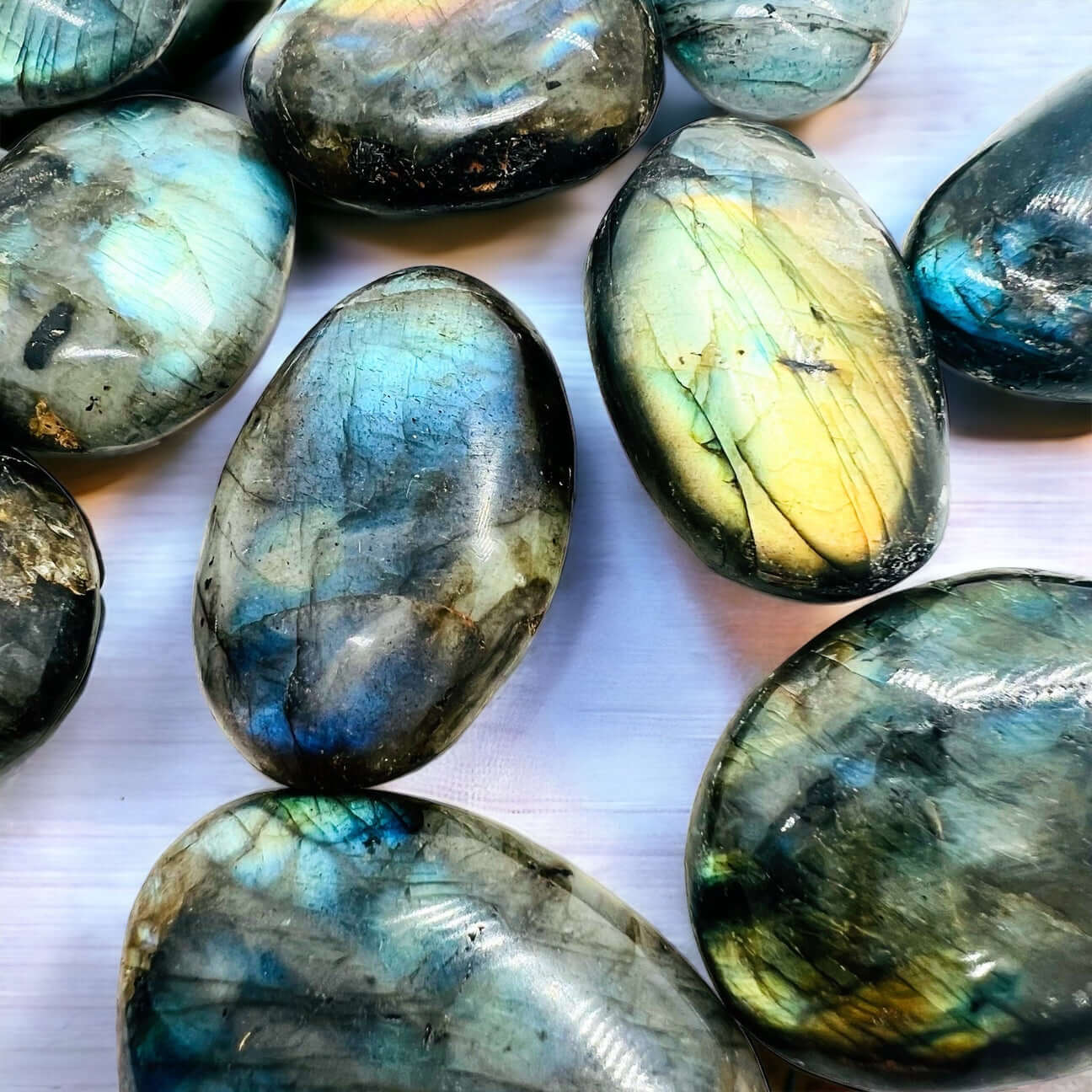 Polished labradorite stone displaying iridescent colors and intricate patterns.