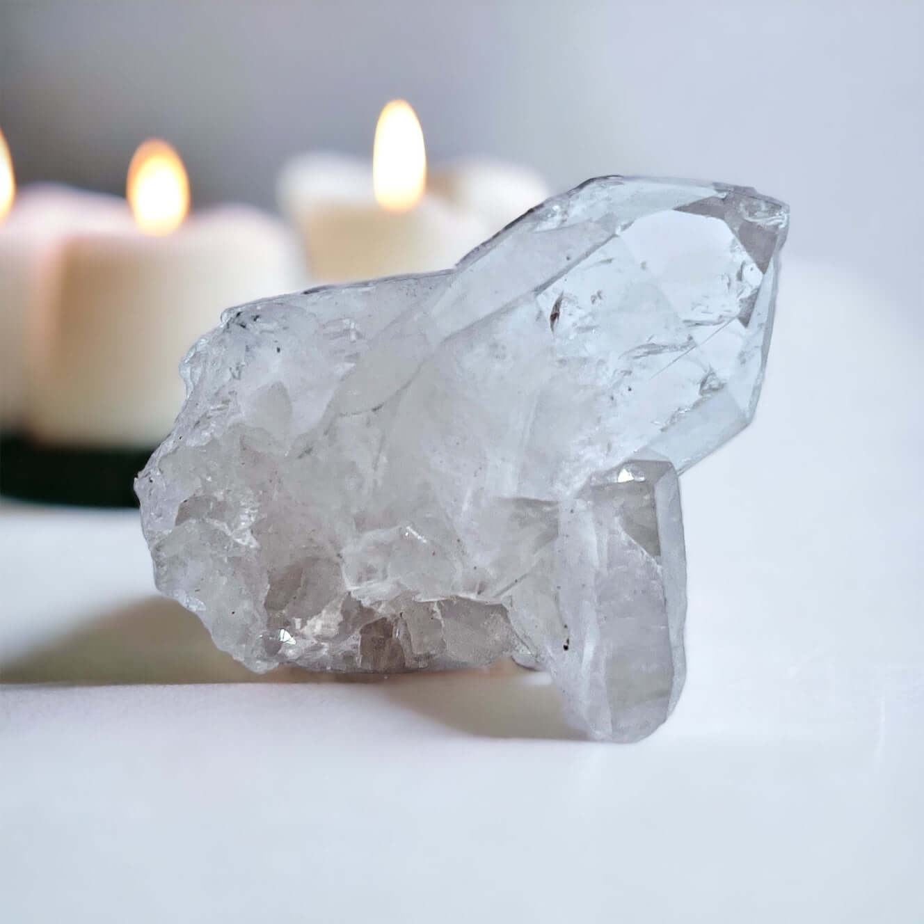 Clear Quartz cluster on white surface 