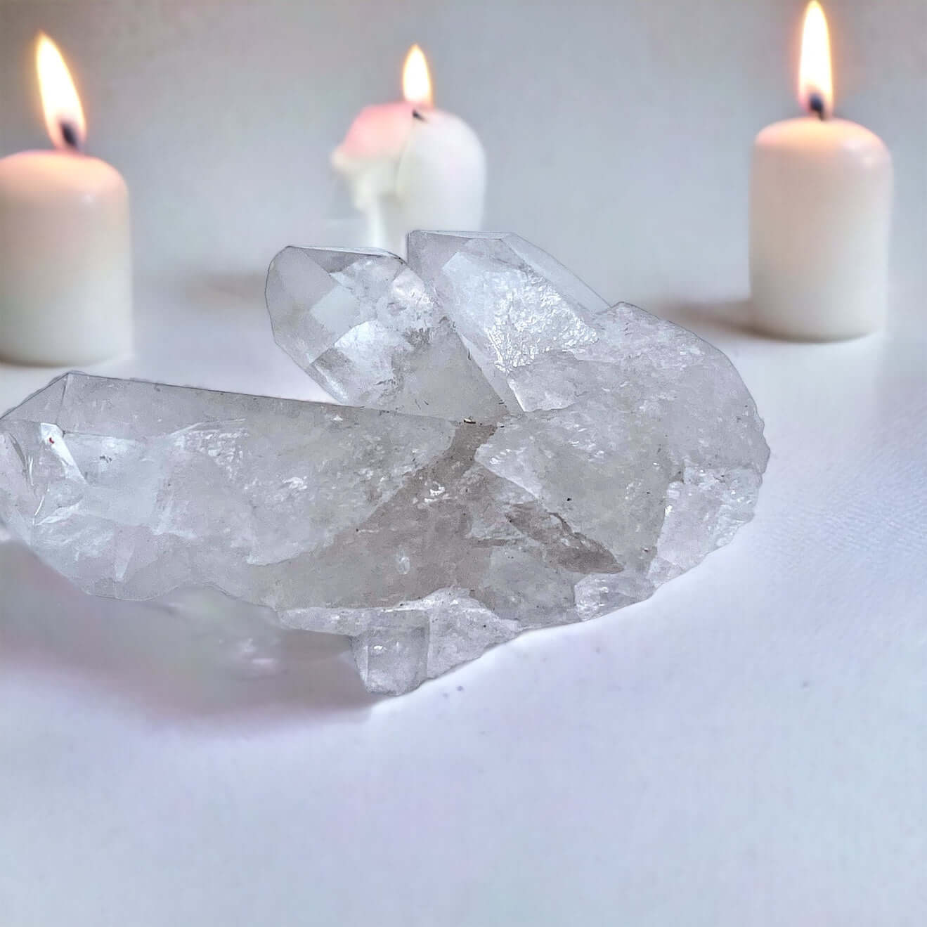 Clear Quartz cluster on white surface