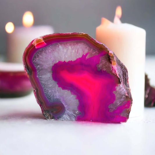 Pink agate candle holder with candles in the background.