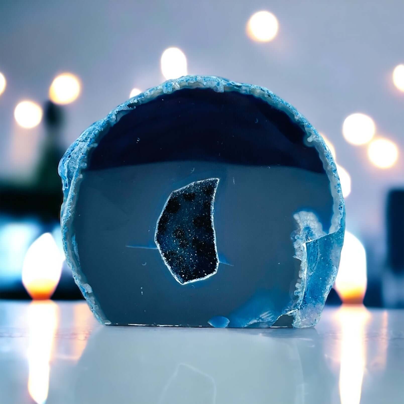 Blue agate geode on white table