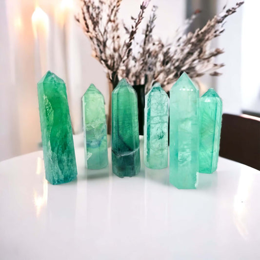 Green fluorite points on white surface.