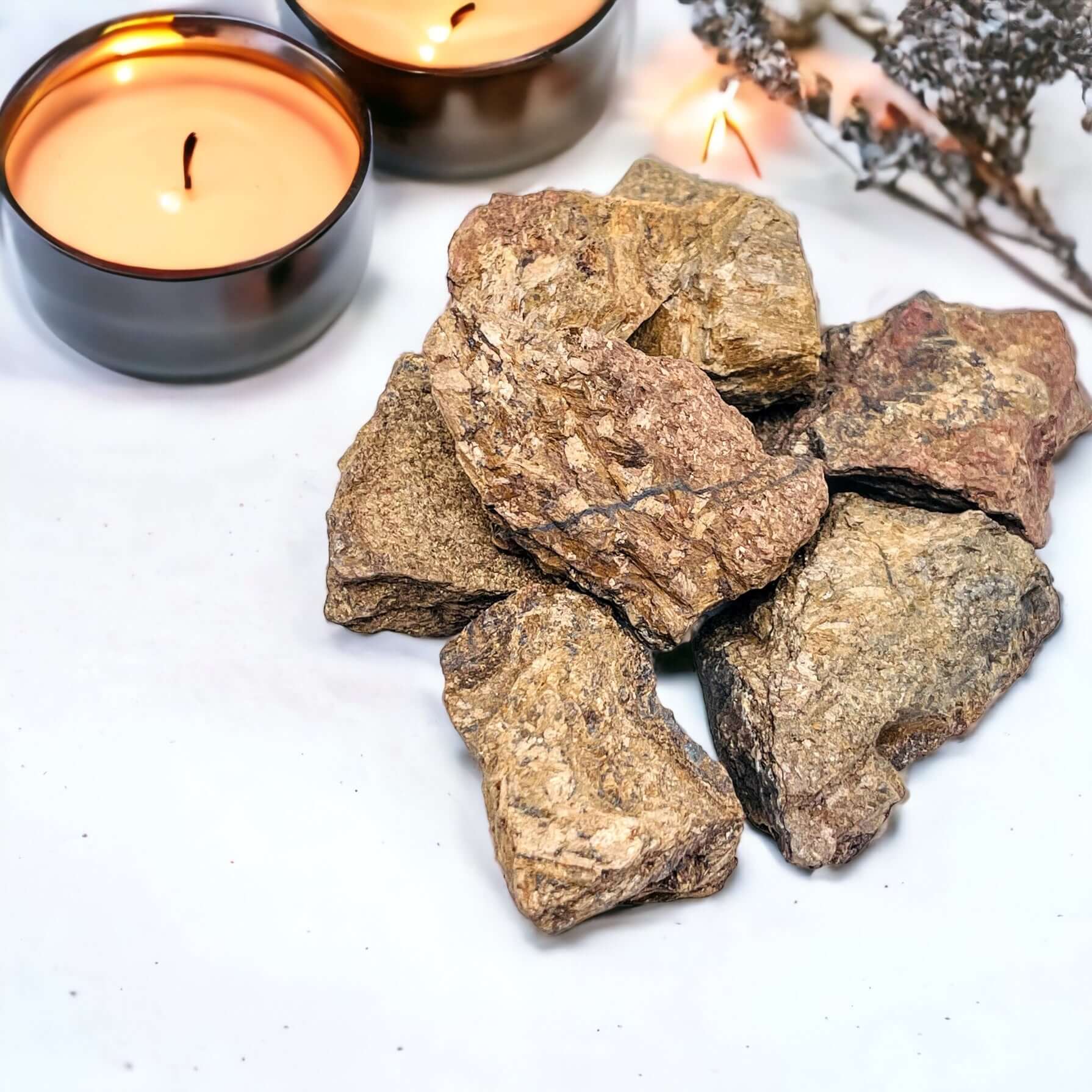 Several polished bronzite slabs on white surface. 