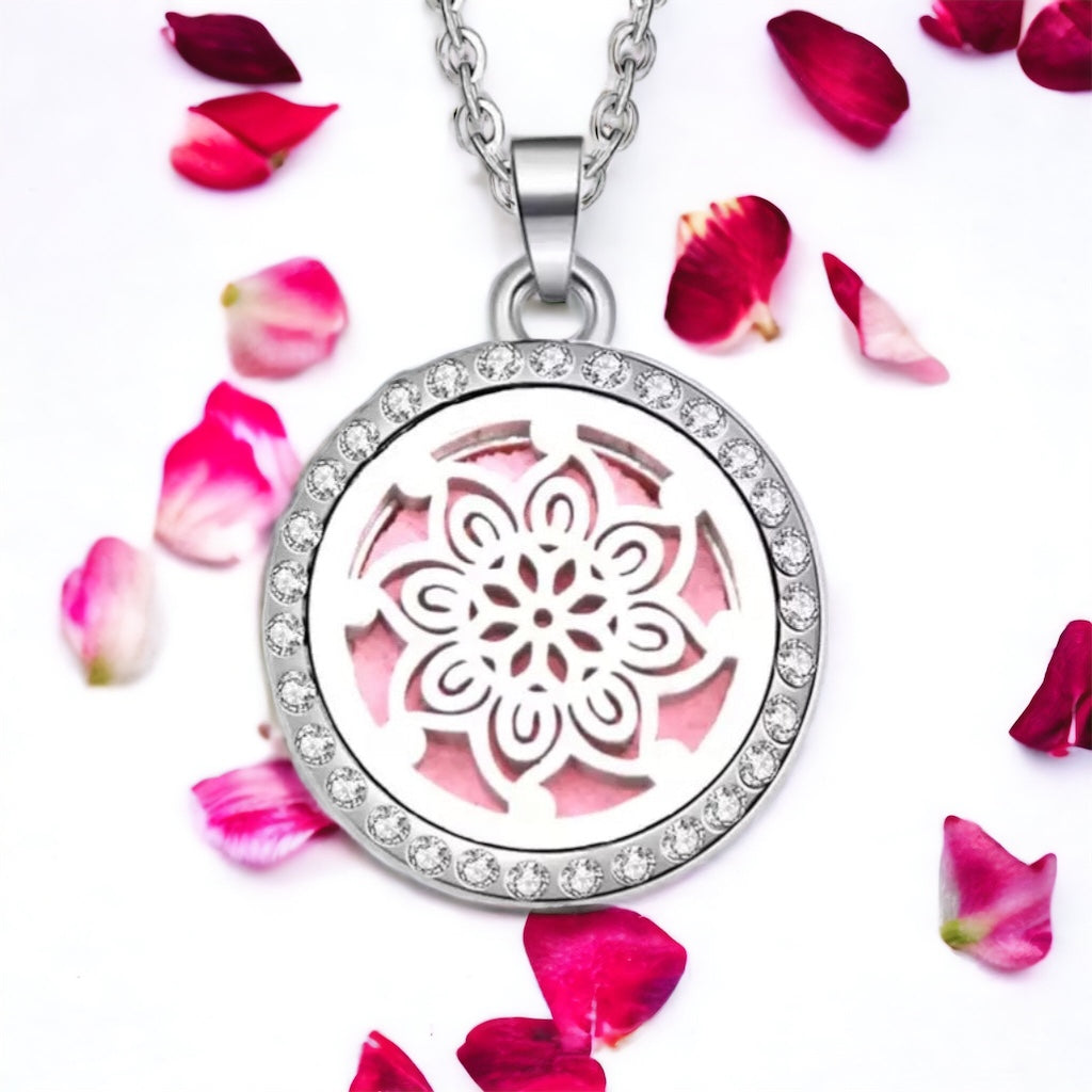 Flower pattern necklace on white surface with scattered petals.