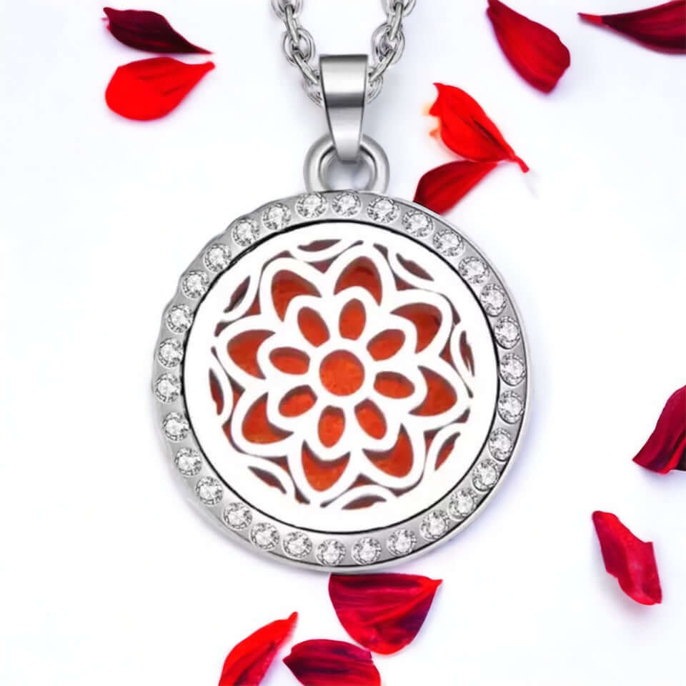 Flower pattern necklace on white surface with scattered petals.