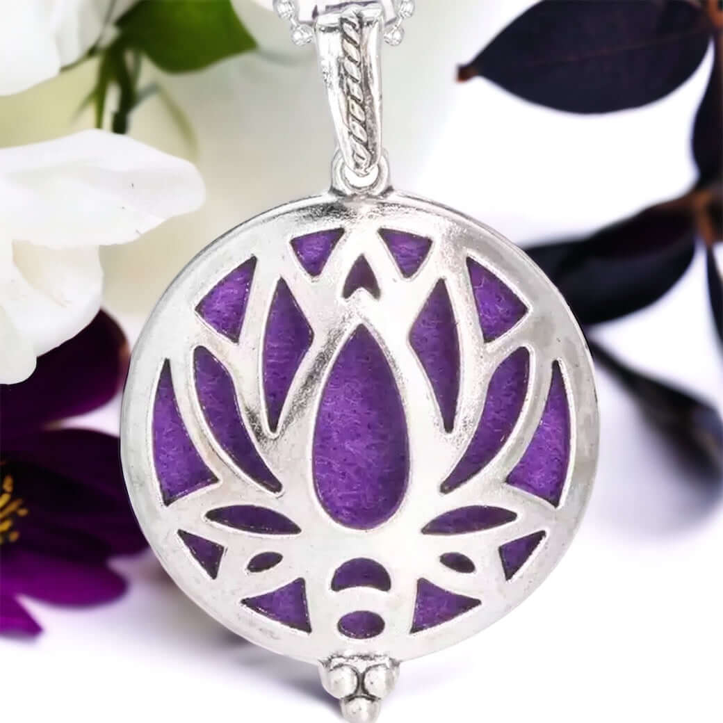 Large lotus Diffuser locket on white surface with scattered petals.