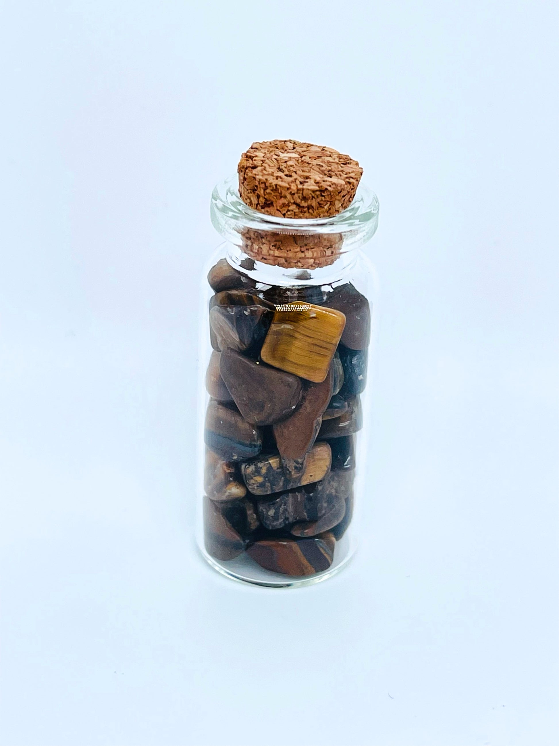 Tiger's eye crystal chip bottle on white background