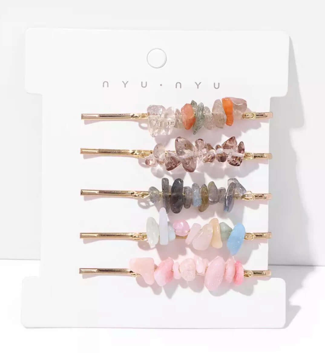 Several hair pins with crystals attached as a set on a card.