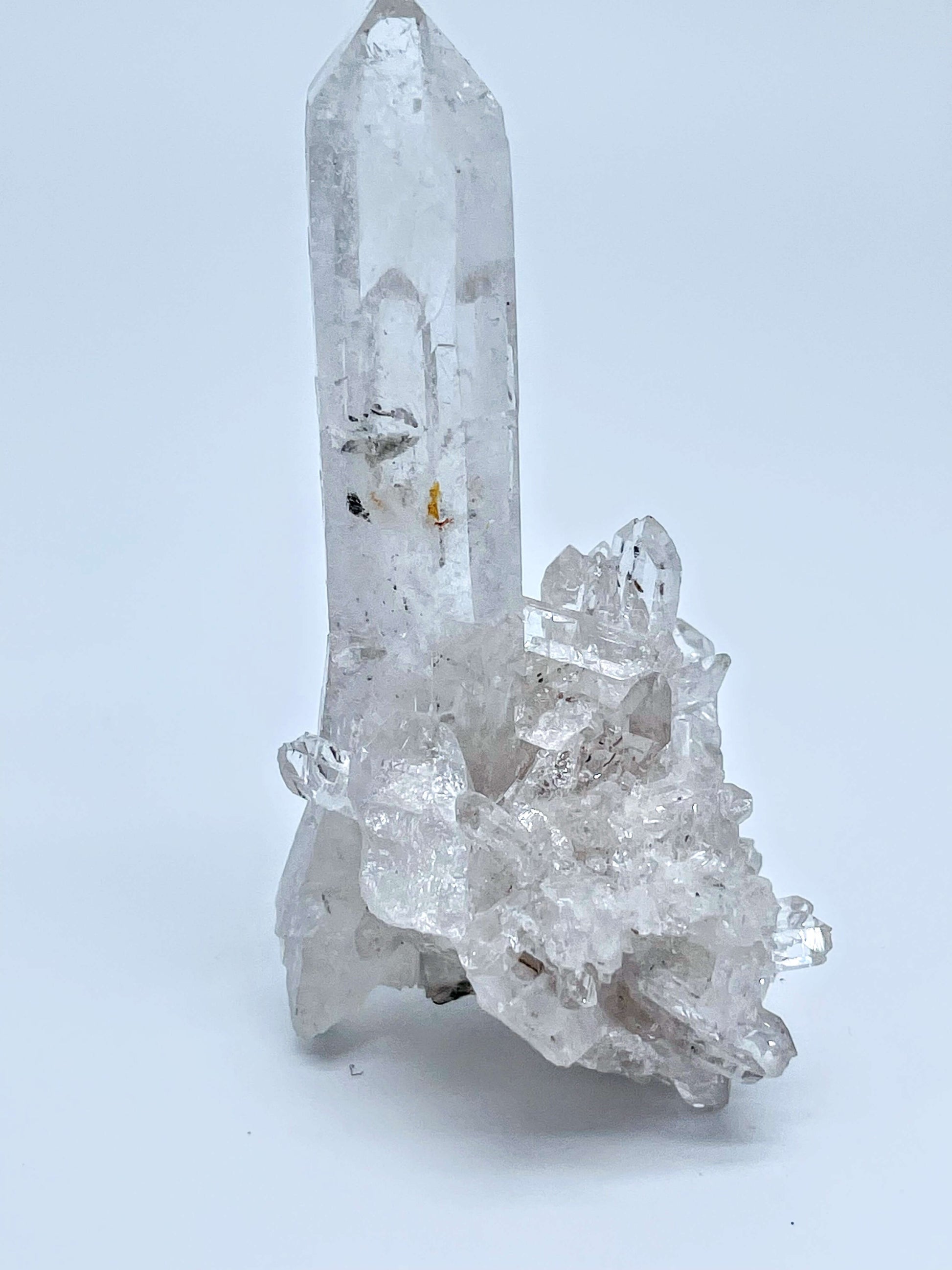 Clear quartz cluster on white background 