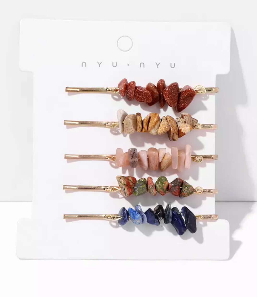 Several hair pins with crystals attached as a set on a card.