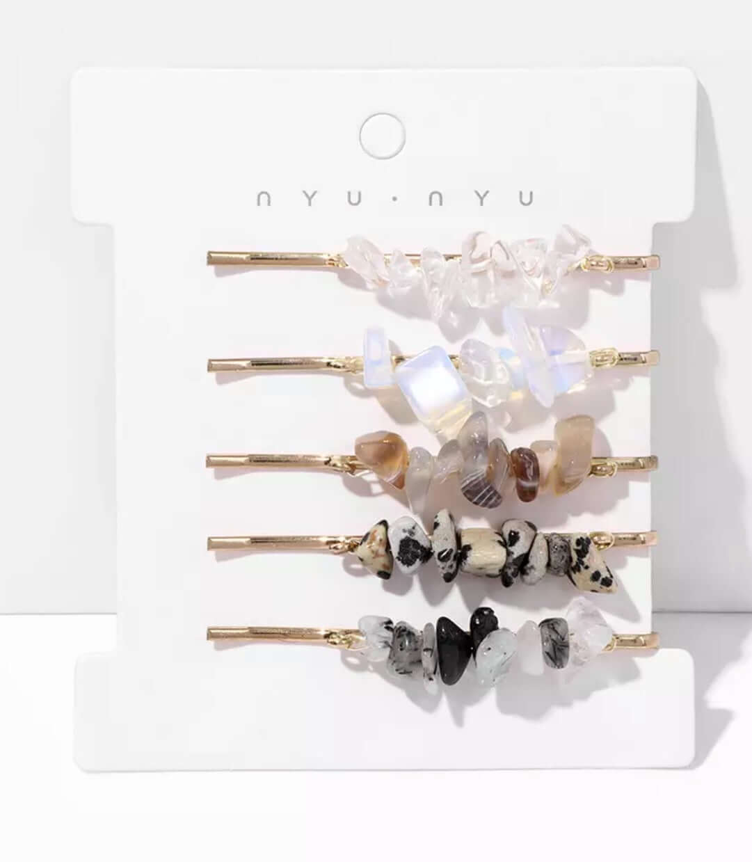 Several hair pins with crystals attached as a set on a card.