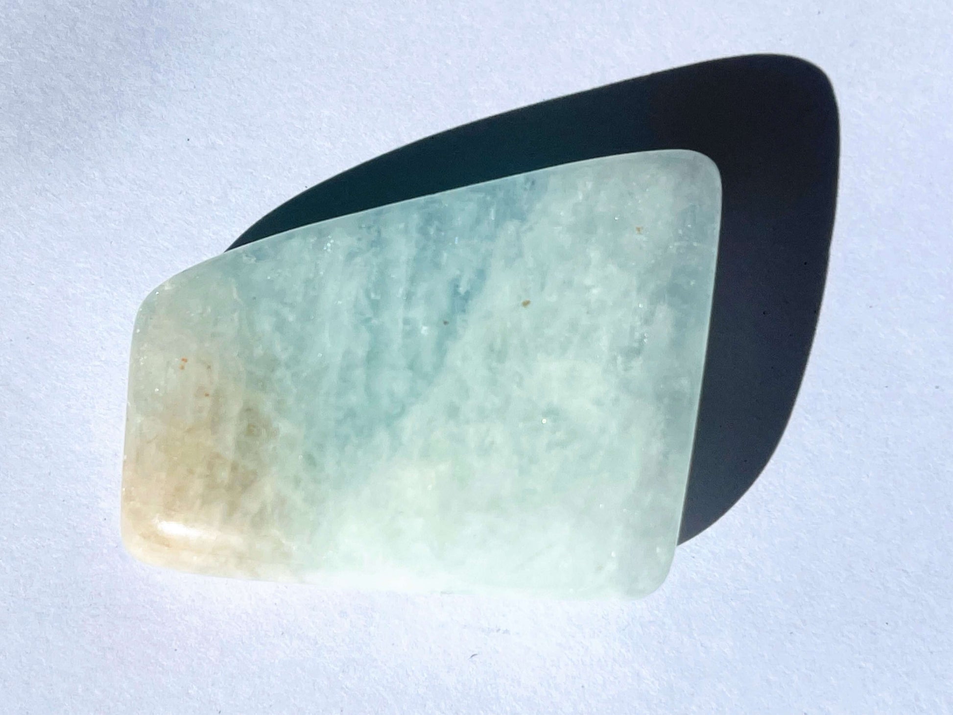 Tumbled aquamarine crystal on white background