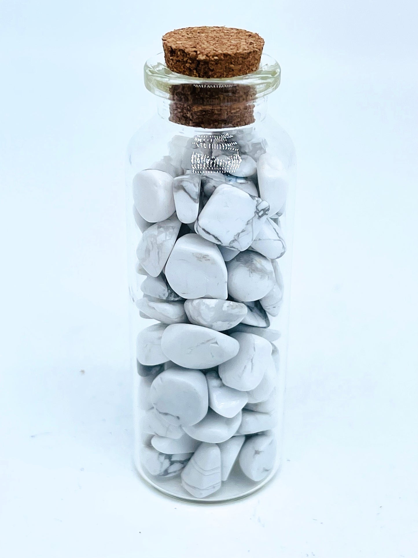 Howlite crystal chip bottle on white background