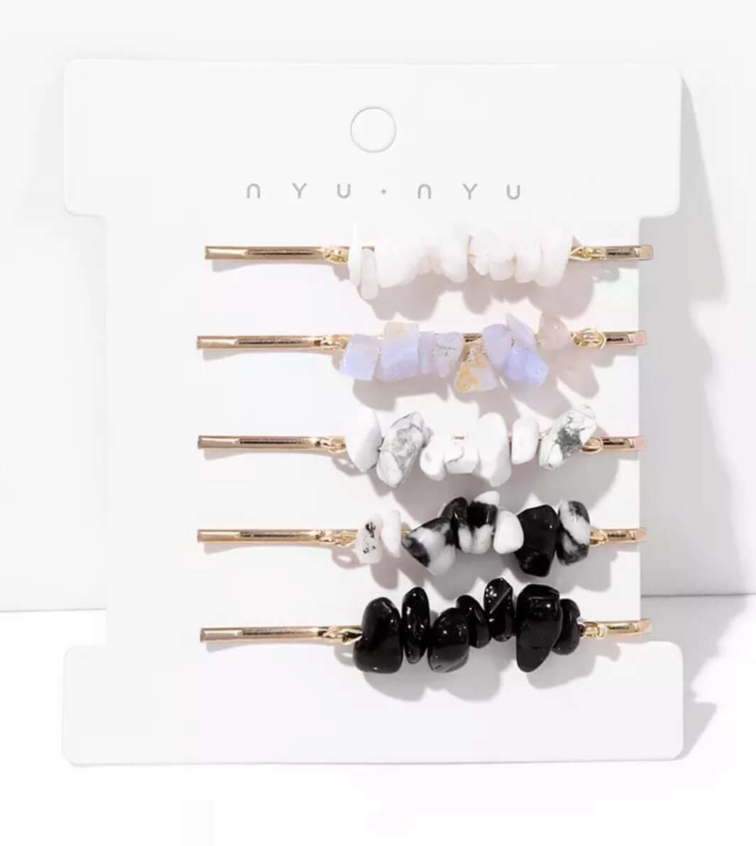 Several hair pins with crystals attached as a set on a card.