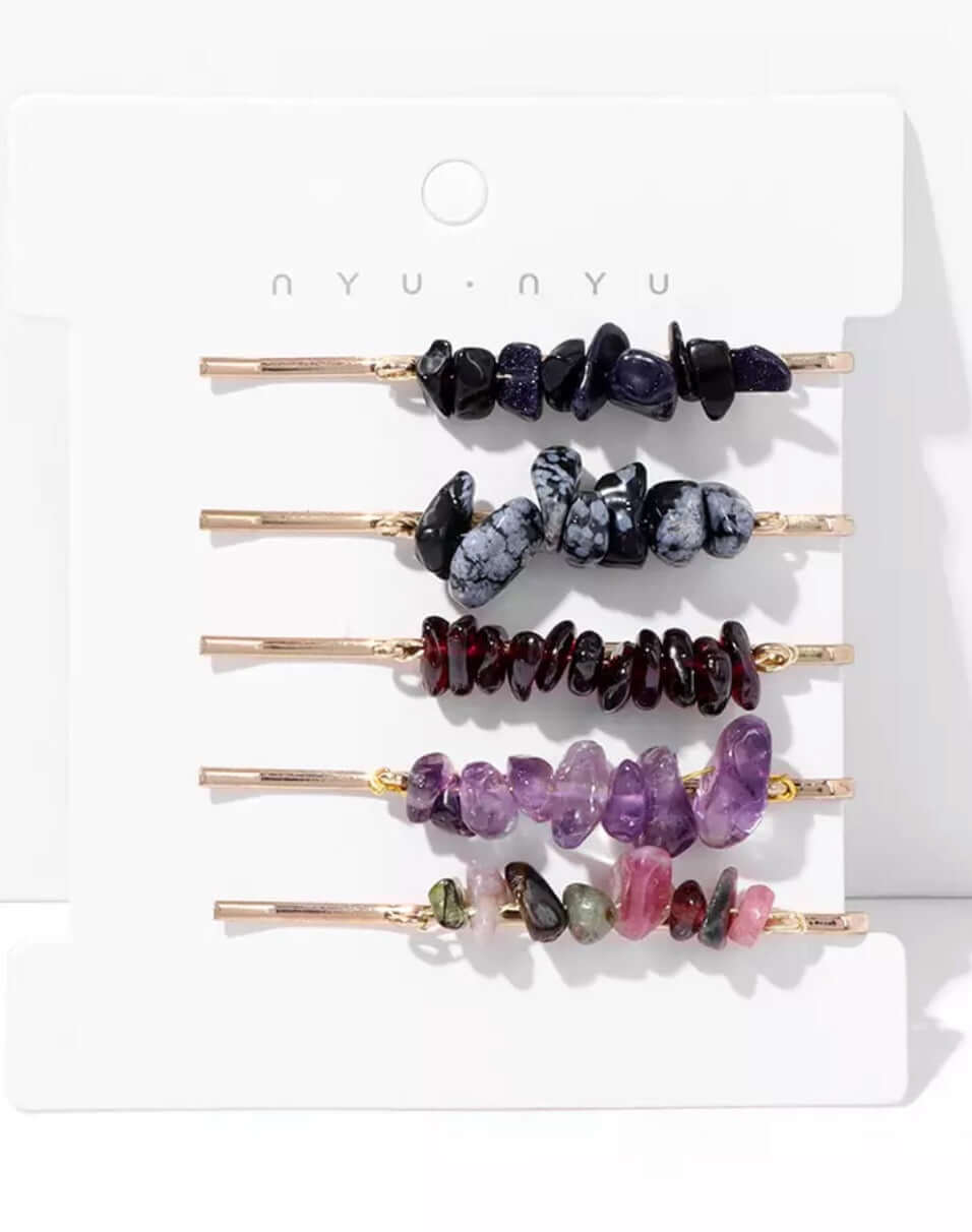 Several hair pins with crystals attached as a set on a card.