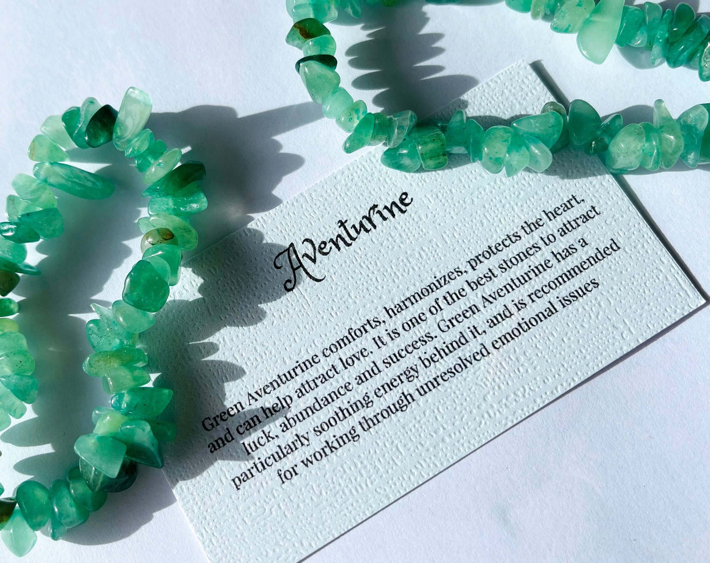 Aventurine crystal chip bracelet with information card on white background