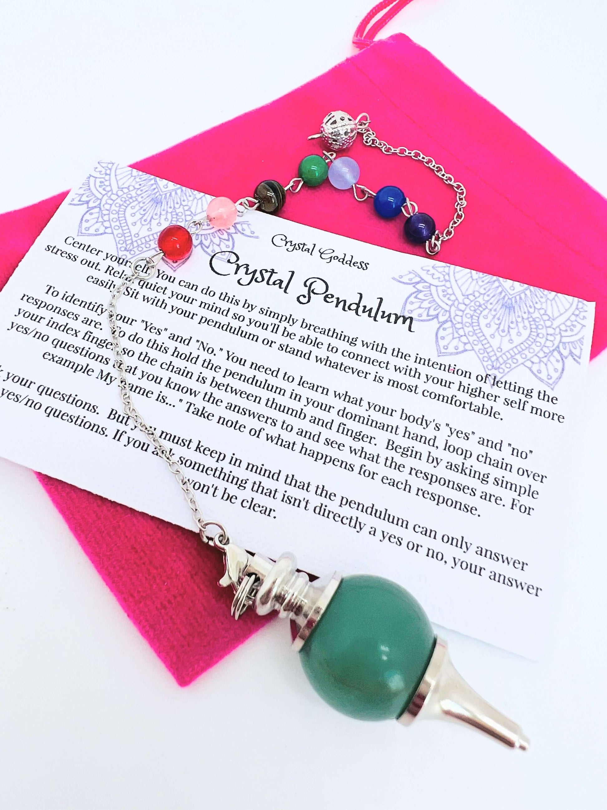 Crystal pendulum with pouch and instructions on white background