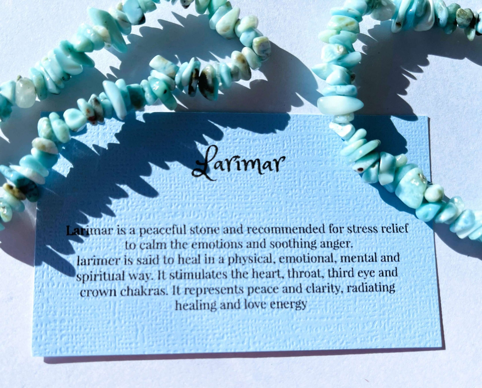 Laramar crystal chip bracelet with information card on white background