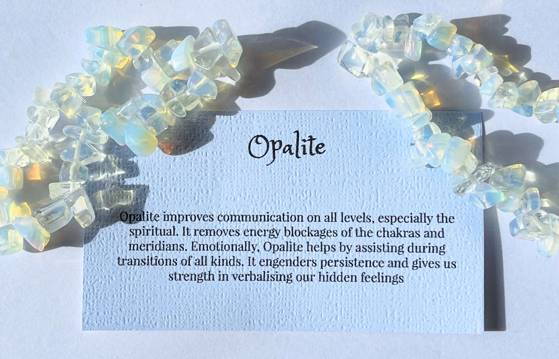 Opalite crystal chip bracelet with information card on white background