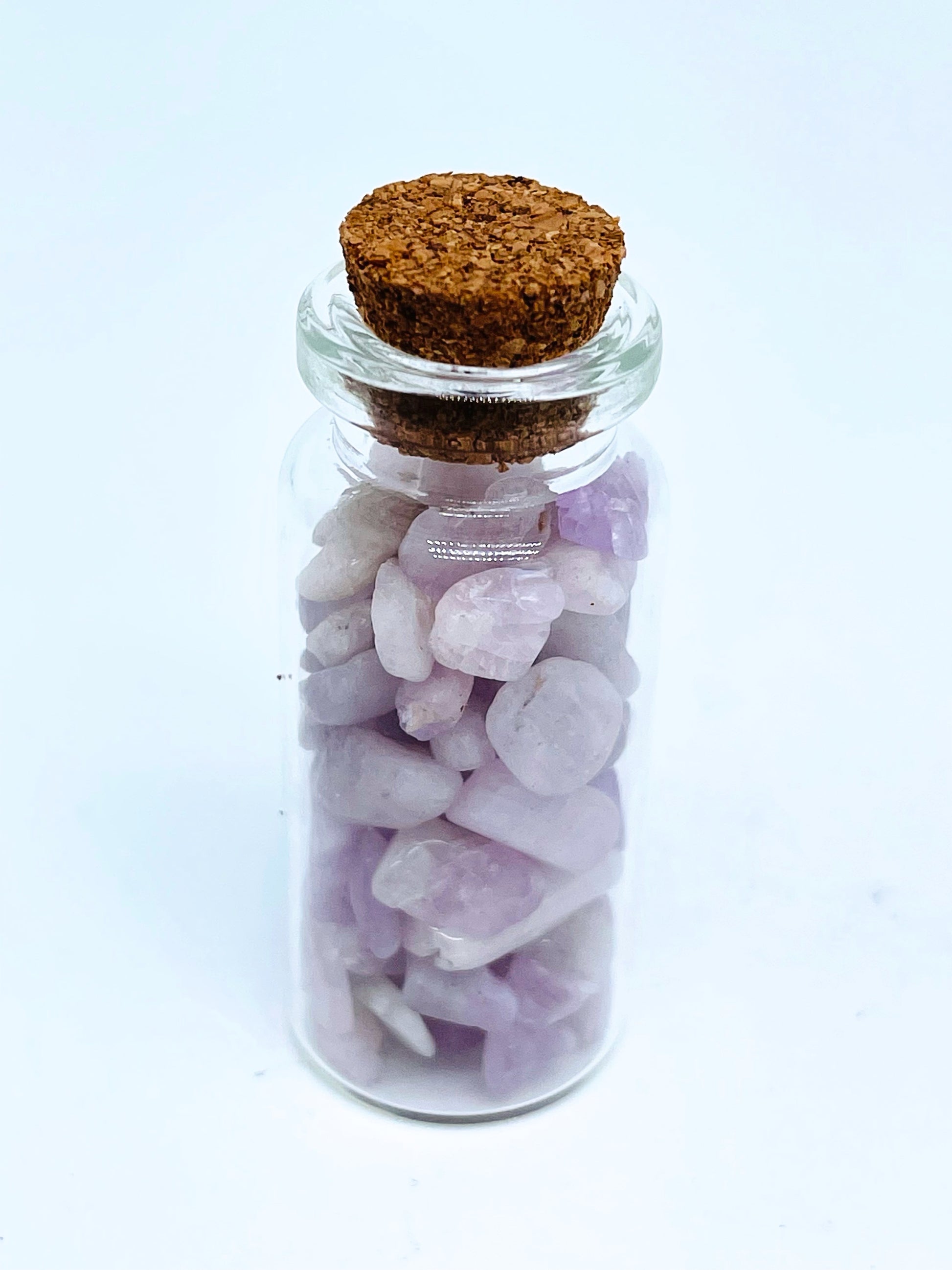 Kunzite crystal chip bottle on white background