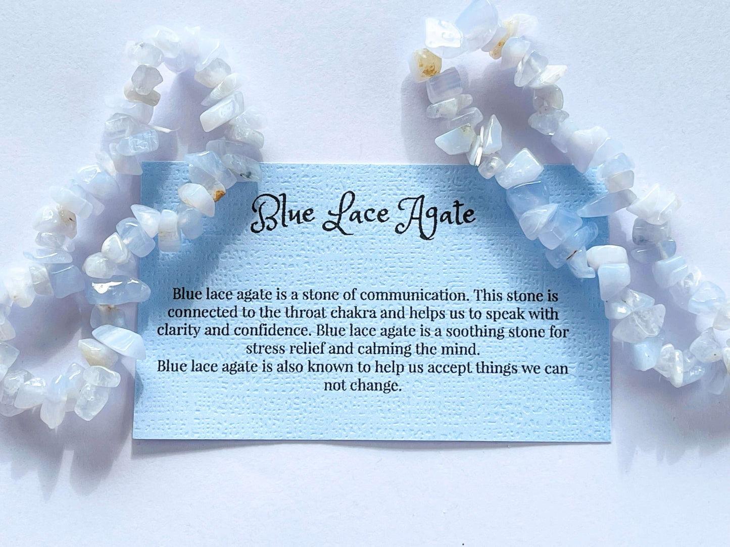 Blue lace agate crystal chip bracelet with information card on white background